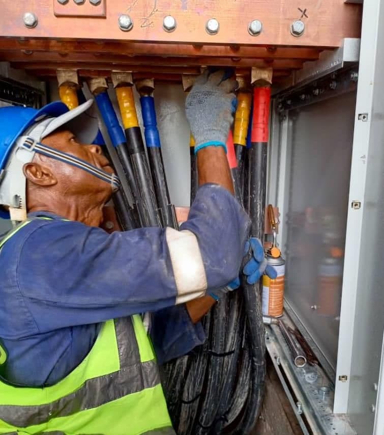 Lobcom technician terminating cables in a distribution panel