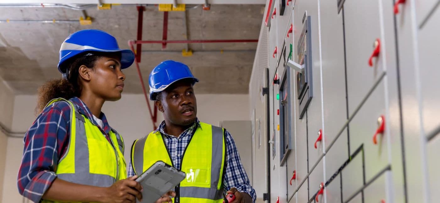 Lobcom engineers reviewing switchgear readings on site